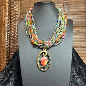 Chicos Bohemian Multicolor Multistrand Beaded Necklace with a Brass Tone Pendant
